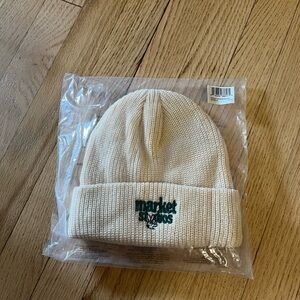 Market Studios Beanie in Ecru with a Green Logo